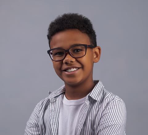 Boy wearing black rectangular glasses and a blue striped shirt
